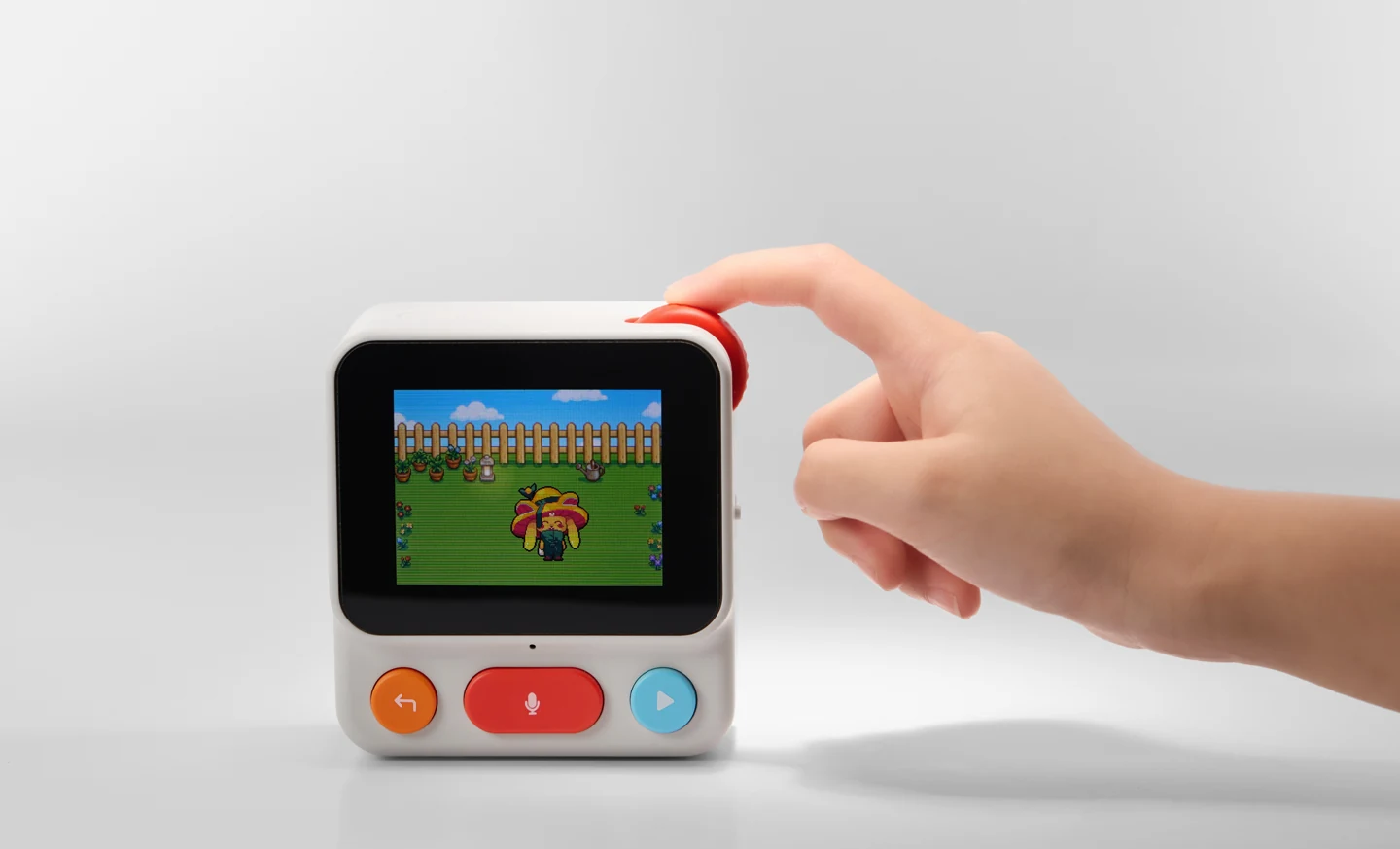 A hand turns the coral scroll wheel on the Nowa device