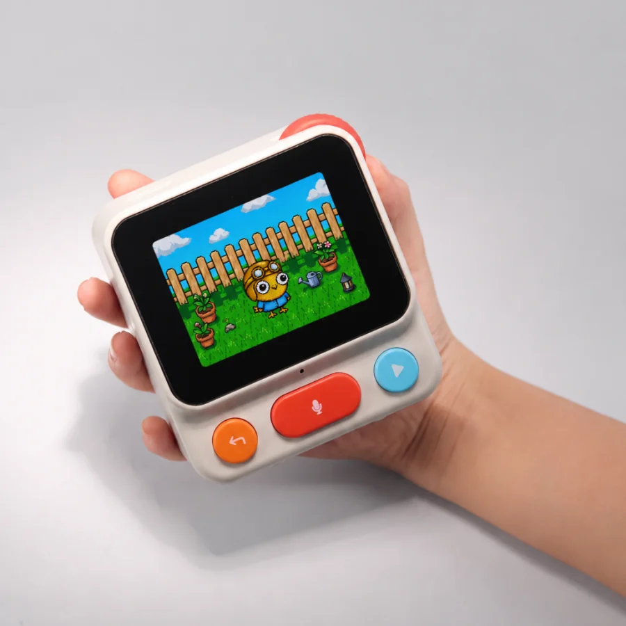 Nowa held in a hand, with a pixel pet playing in its garden